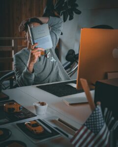 Freelancer organizing receipts, mileage records, and a laptop at a home workspace.
